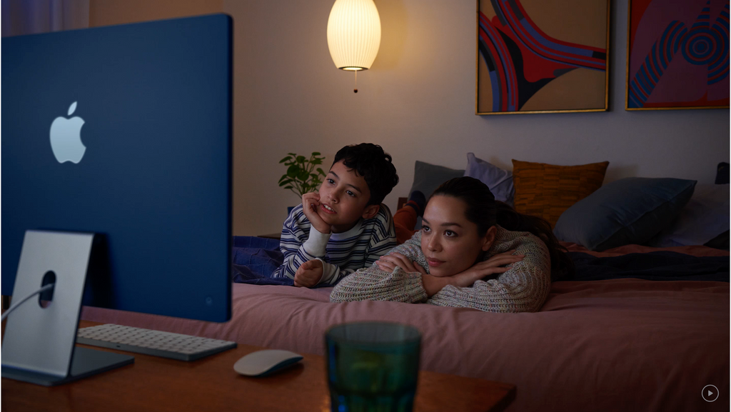 24" iMac with mom and child watching Apple TV Plus