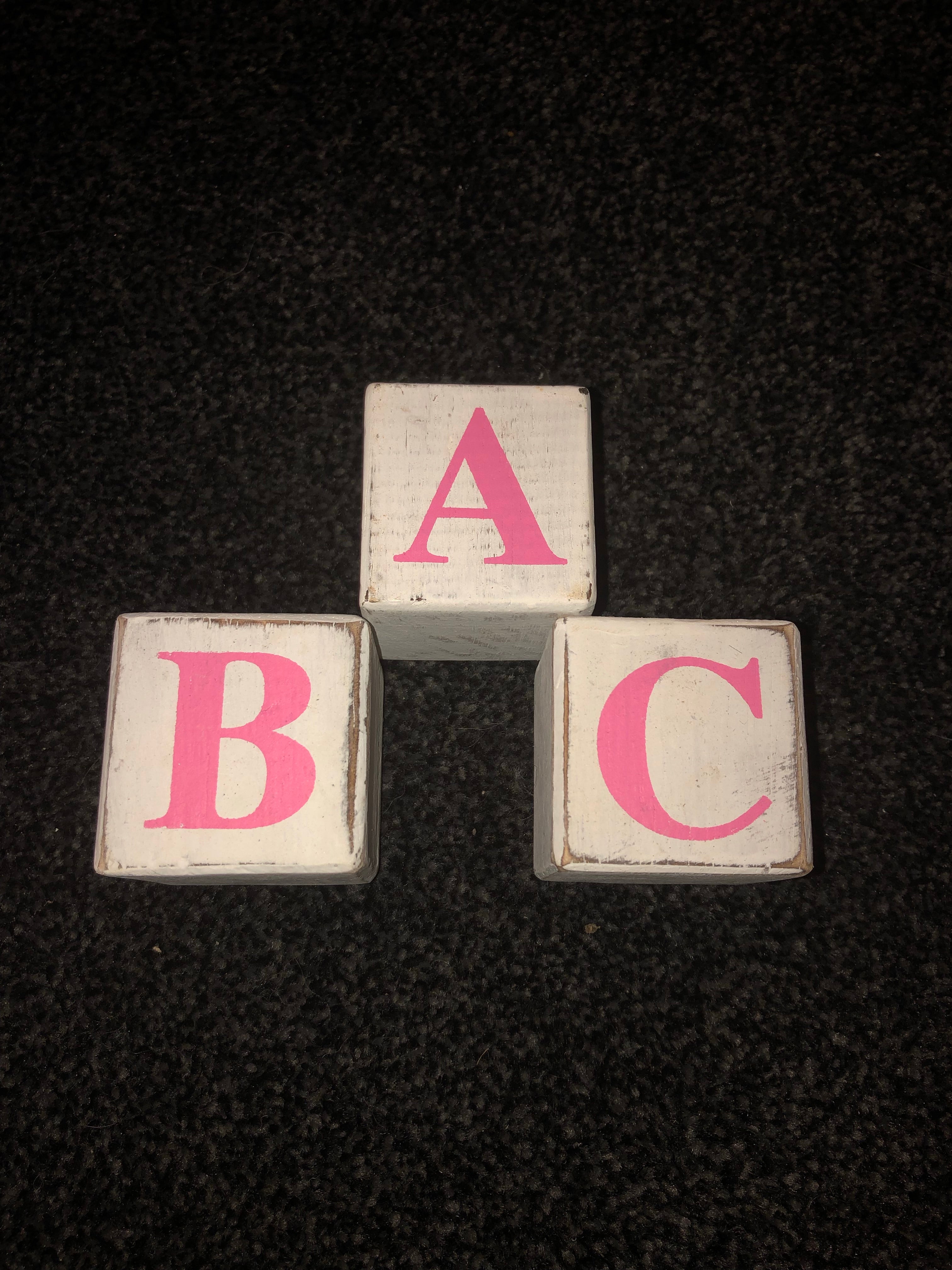 pink wooden alphabet blocks