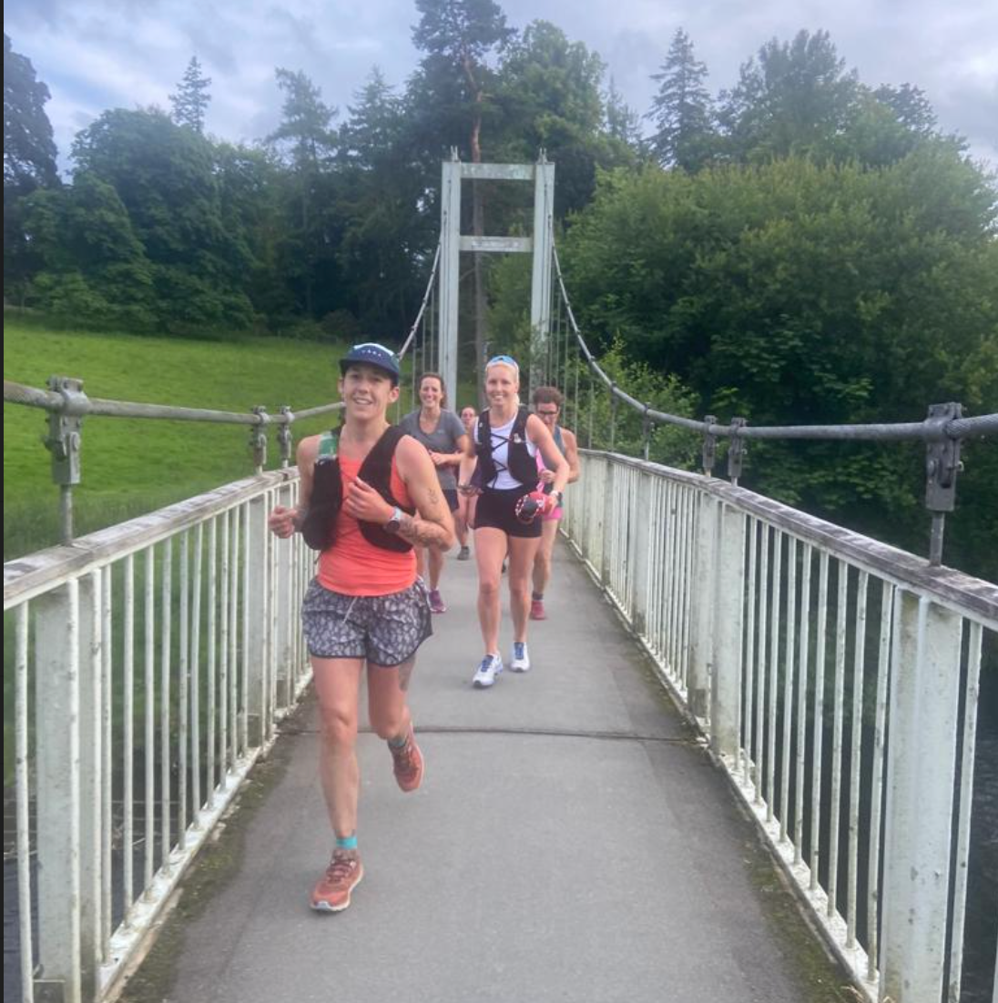 group of women running across bridge