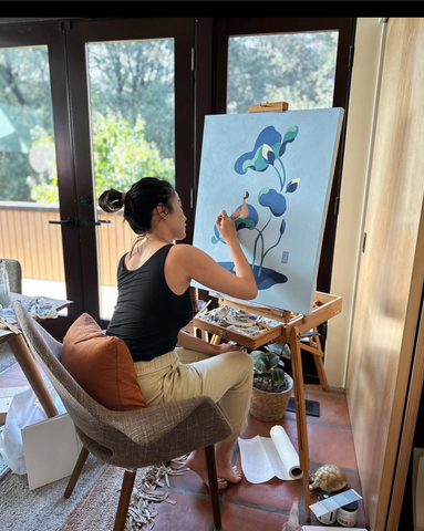 Image of Mimi painting inher studio