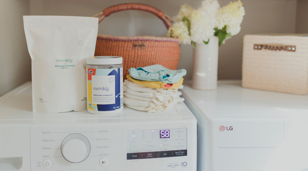 Esembly washing powder on top of a washing machine