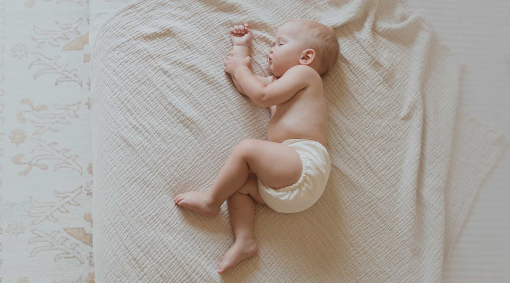 newborn baby sleeping weathering a white cloth diaper from Esembly