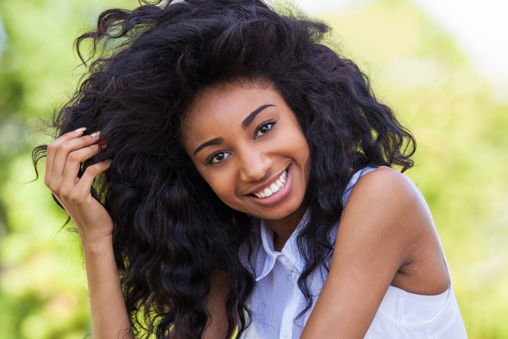 Woman with natural textured hair enjoying a sunny day