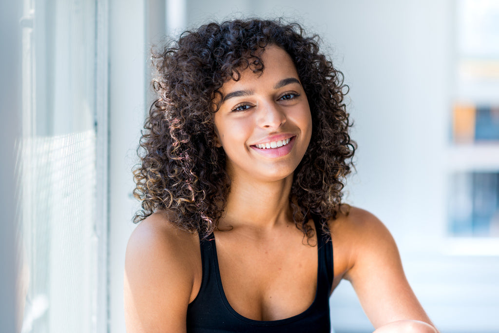 beautiful woman with medium-length coily hair in a natural hairstyle