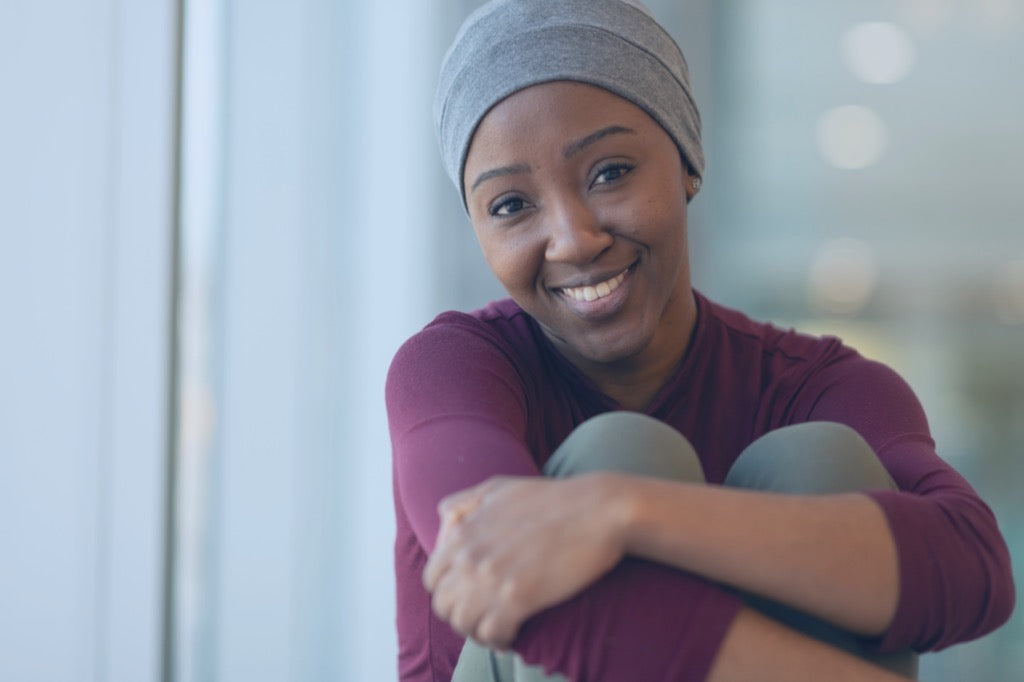 Woman with a head wrap over her box braids getting ready for bed