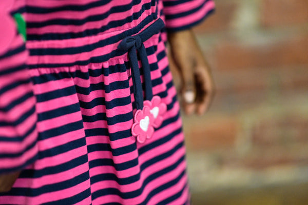 pink and black stripe dress with pink flower appliqué