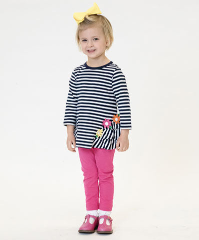 girl in stripe tunic with flower appliqué and pink leggings