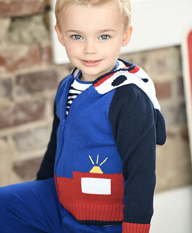 young boy in red, navy and blue sweater with spotted puppy hood