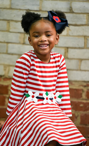 young girl in red and white stripe dress with flowers