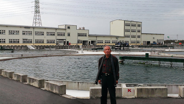 Prof. Dr. Wang Shun Te with his production factory in the background.