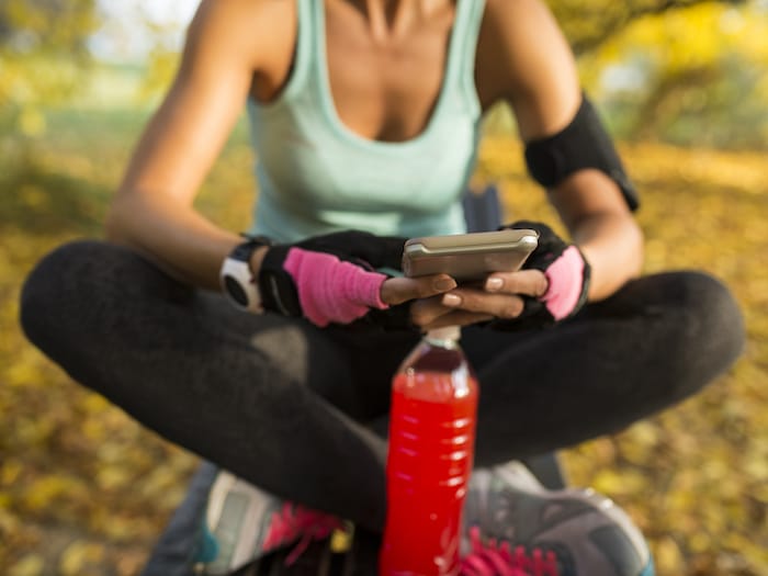 Lady checking her phone after exercise