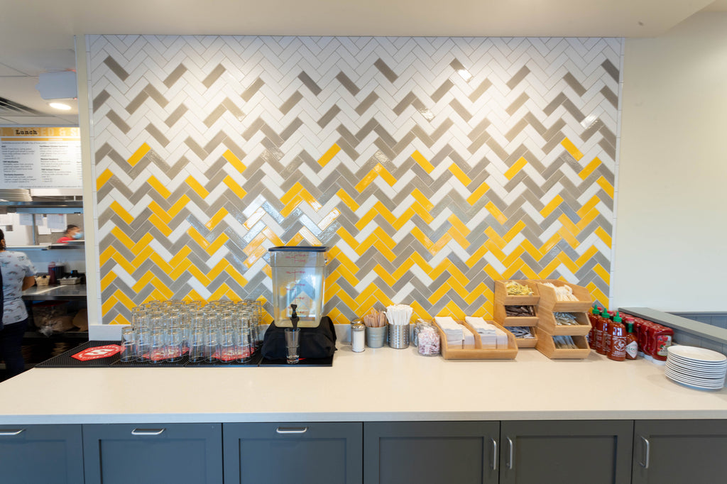 yellow and white ombre herringbone backsplash