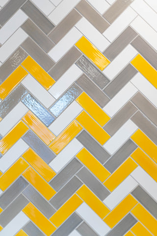 yellow and white ombre herringbone backsplash