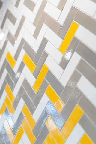 yellow and white ombre herringbone backsplash