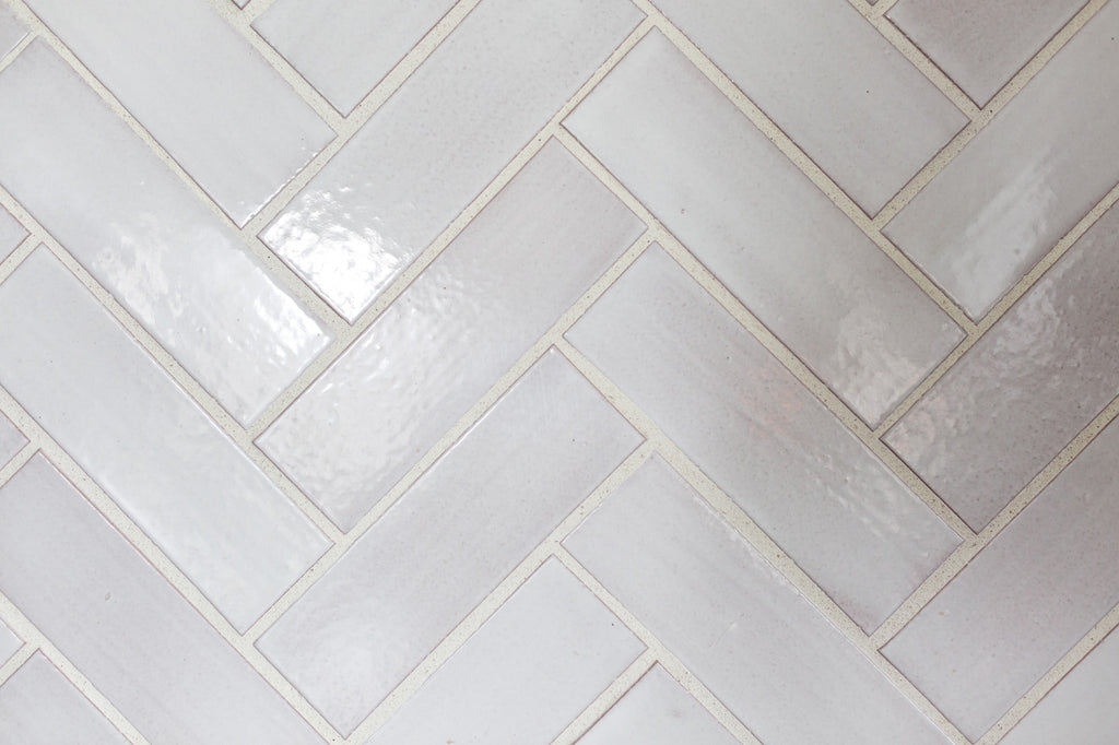 white herringbone kitchen tile backsplash