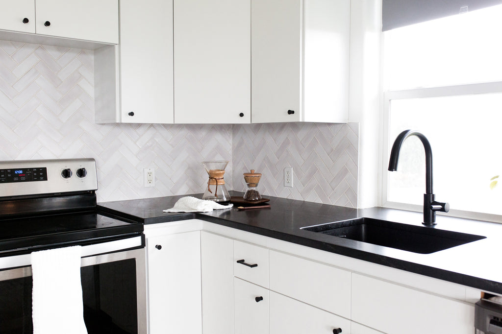 white herringbone kitchen tile backsplash