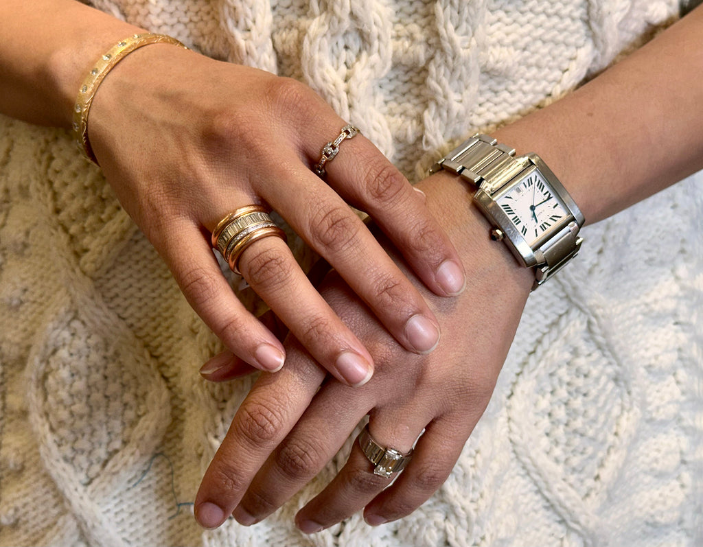 Closeup photo of Prerna's hands. Prerna is wearing her Sethi Stack and a wristwatch.