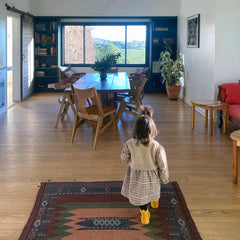 Image of Prerna's daughter, Pia, walking in the dining room