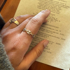 Prerna wears the Link Diamond Two-Tone Gold Band while looking at a restaurant menu