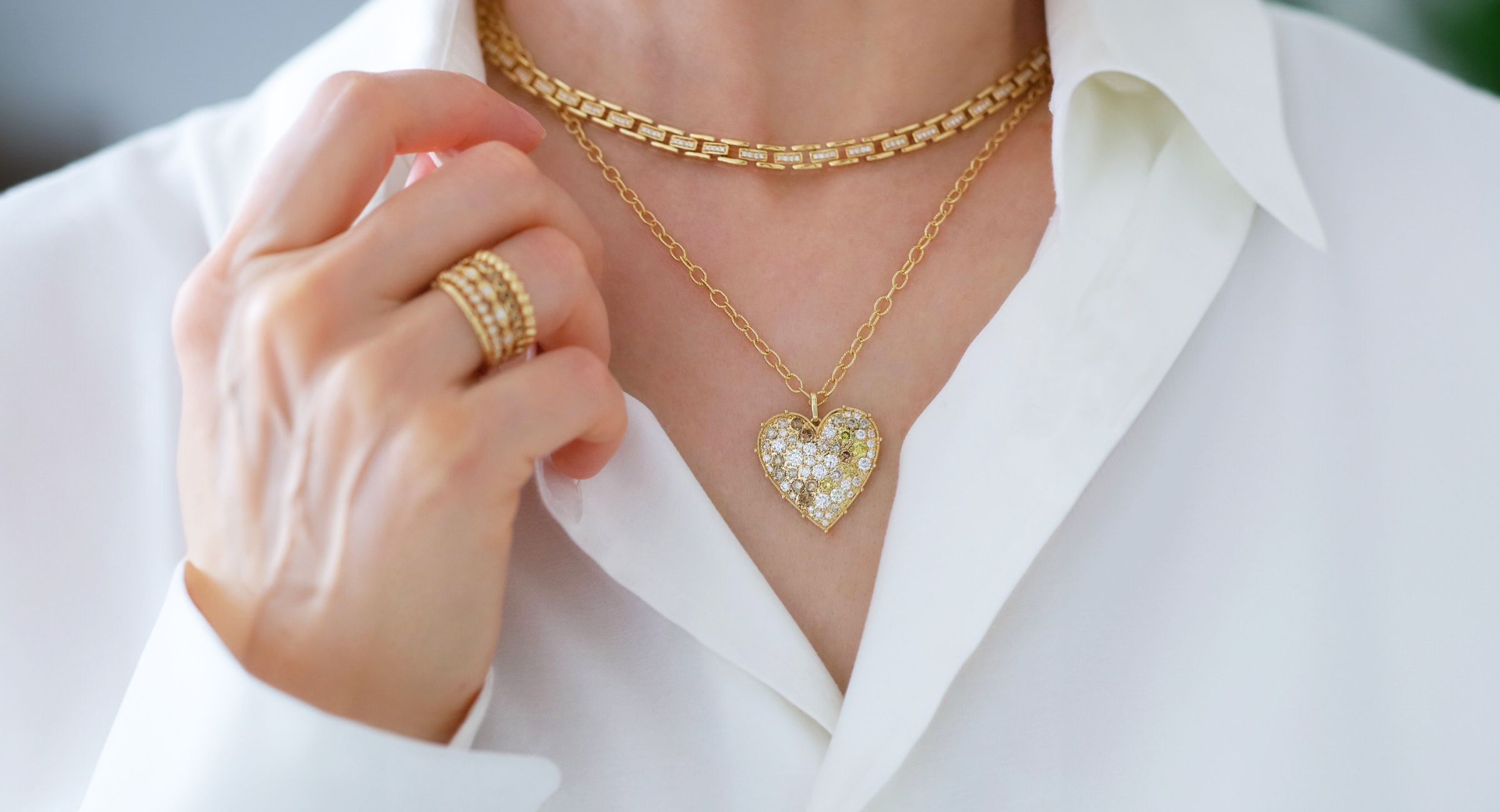 Model wears Cesta White Diamond Necklace layered with Confetti Heart Multi-Color Diamond Pendant