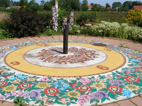 ground shadow clock painted in floral motives