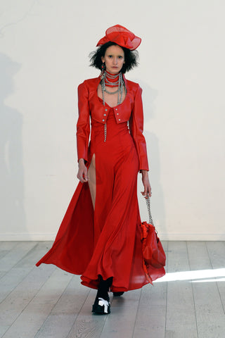 Lula Laora ss22 the garden Getty runway, long red dress with two high slits, red leather jacket, red hat. 