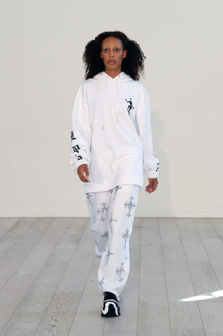 Lula Laora ss22 the garden Getty runway, white hoodie, white joggers/sweatpants with black detailing. 