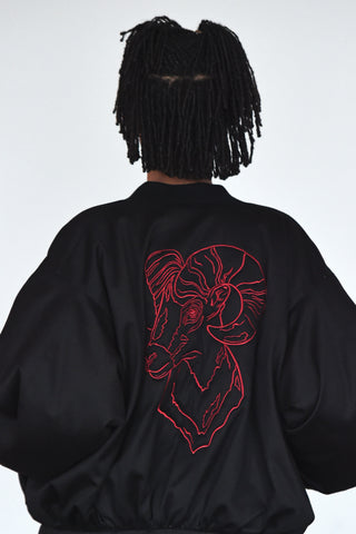 LULA LAORA AW21 Getty Images, womenswear model wears a black bomber jacket, the back has an embroidered ram. 