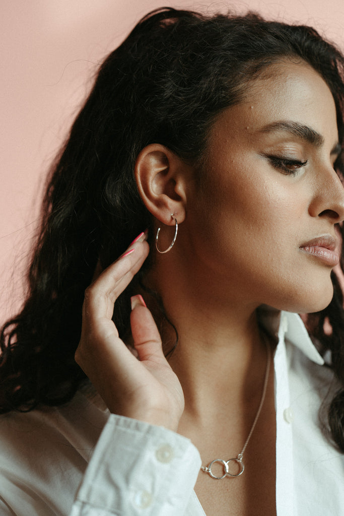 Open hoop stud earrings in hammer textured sterling silver by Mikel Grant Jewellery