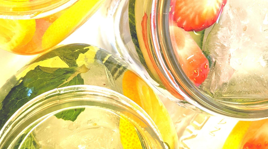 3 mason jars of infused fruit and herb spa water