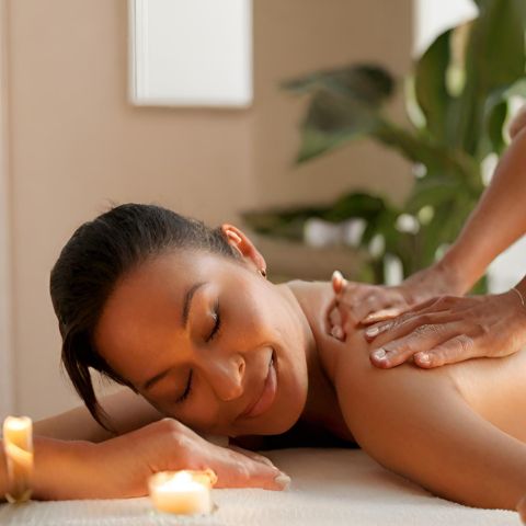 A woman enjoying a relaxing massage in a cozy room.