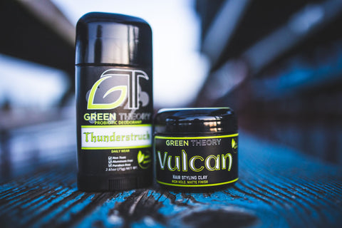 photograph of green theory Thunderstruck probiotic aluminum free deodorant and Vulcan natural hair styling clay sitting on an old blue painted piece of wood