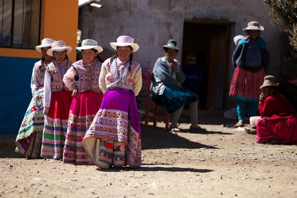 Children dance in the Highlands wearing ornate traditional Peruvian textiles