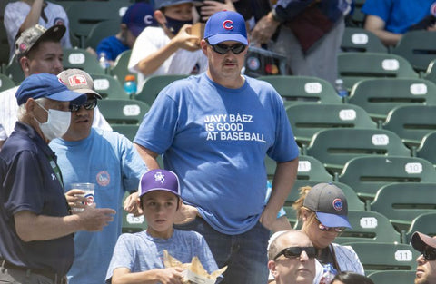 Cubs fan behind one-liner shirts