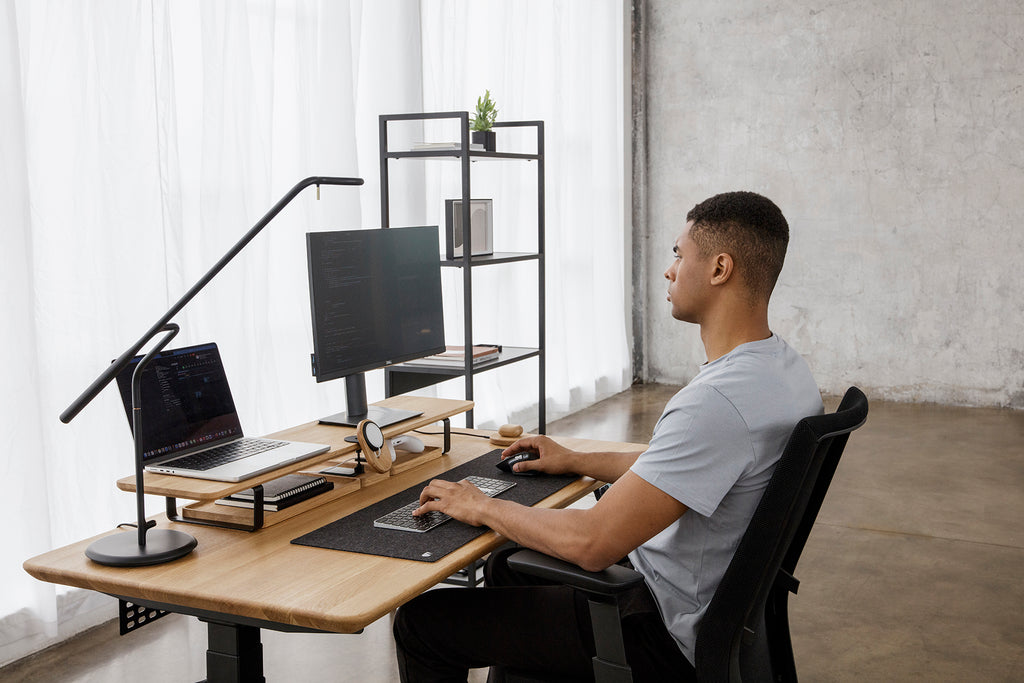 man working on two screens