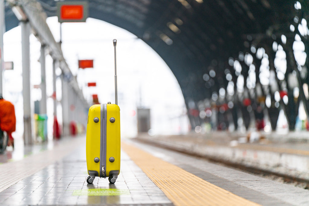 yellow suitcase on a train station