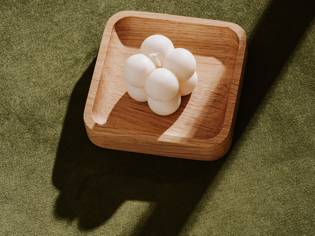 candle on a wooden tray