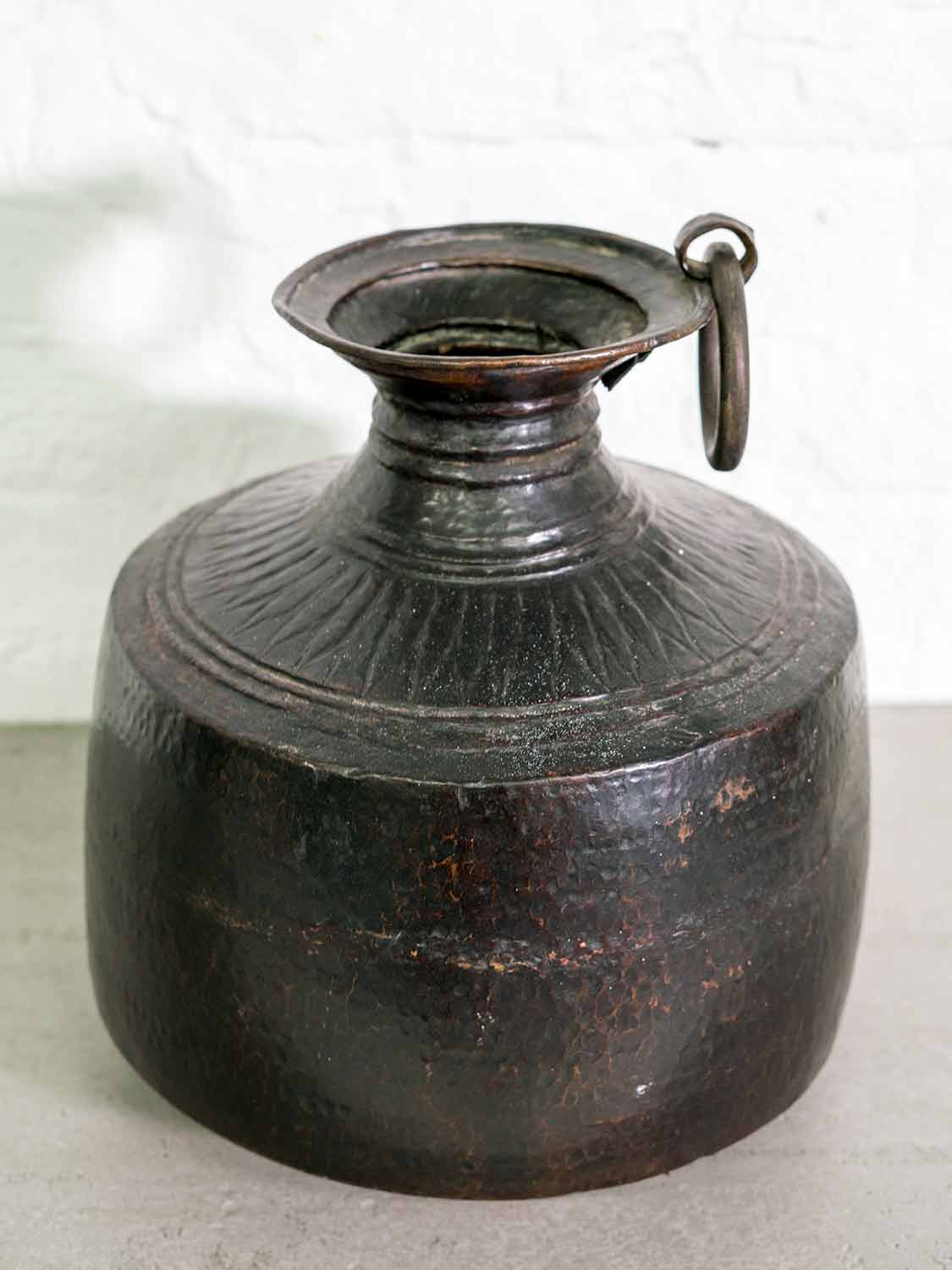A blackened copper vase that's an everyday water pot from India