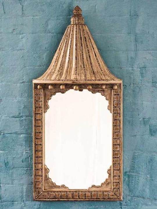 An unusual and very decorative canopied Indian mirror.