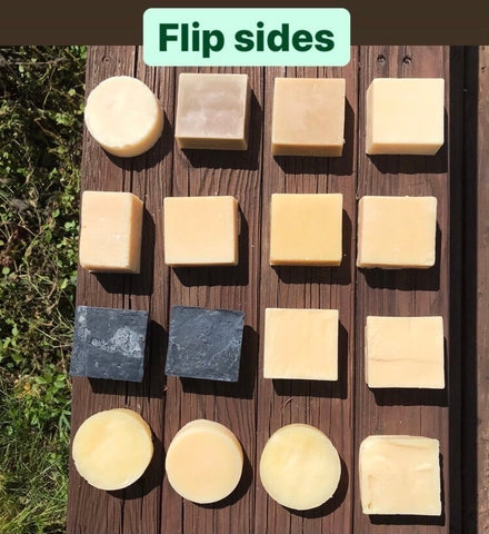the same bars of soap in a four by four grid but bars are turned to the other side, text says flip sides