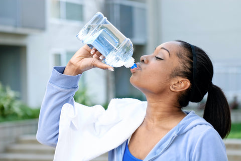 Woman drinking more water to stay hydrated and health for summer