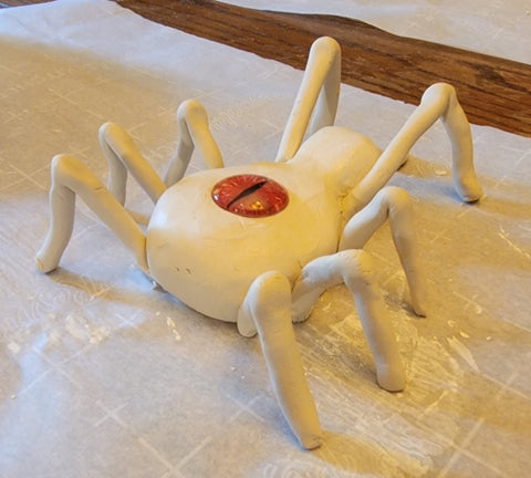 attached legs of spider sculpture