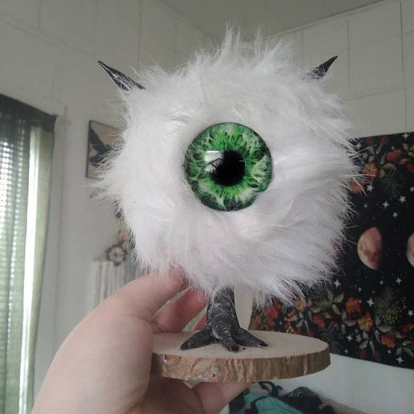 buddy fluffy sculpture with green glass eye
