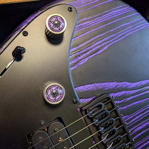 black and purple instrument knobs with glass eyes