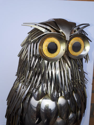 metal owl sculpture with yellow owl glass eyes