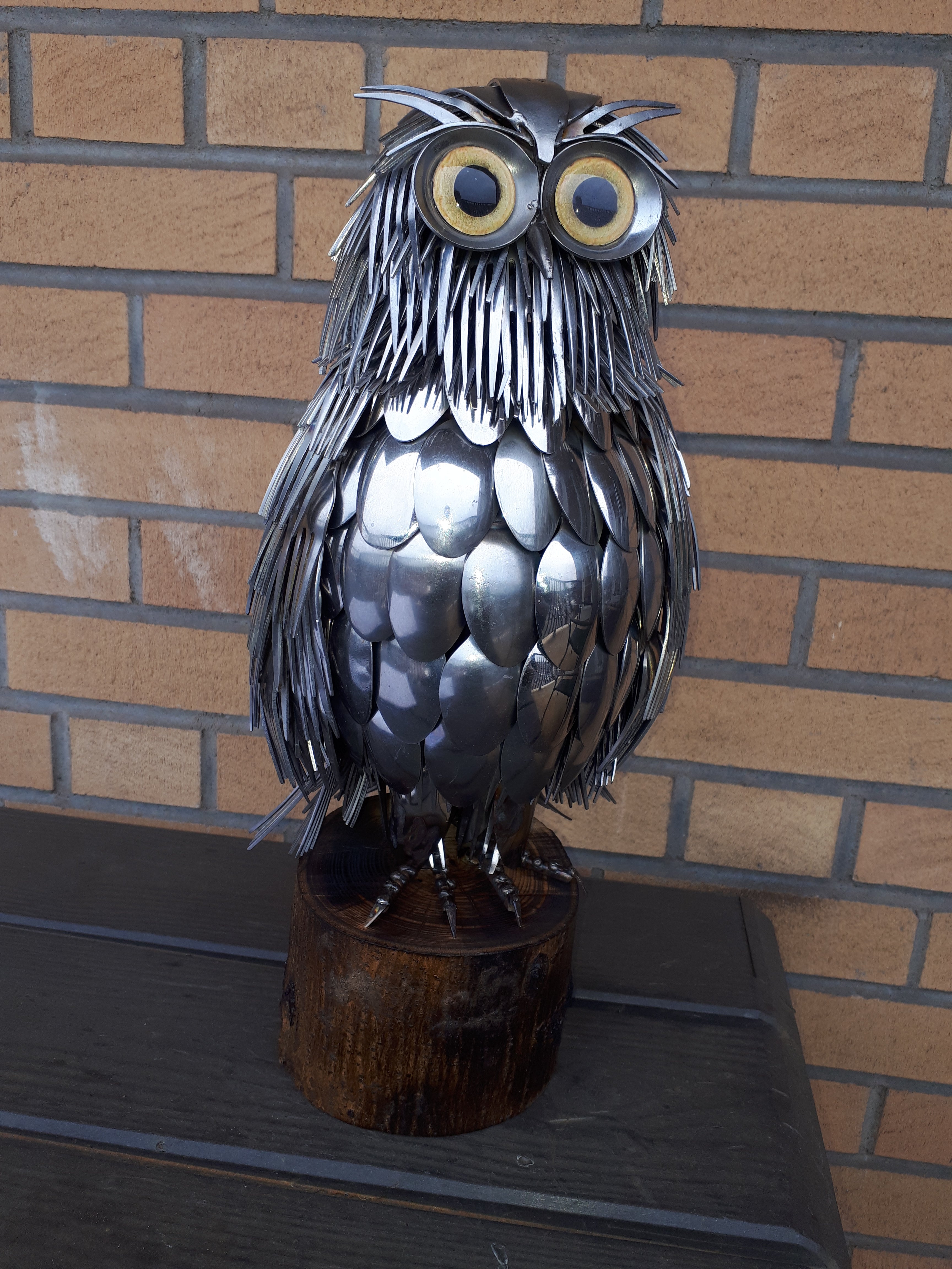 metal cutlery owl sculpture with yellow glass eyes