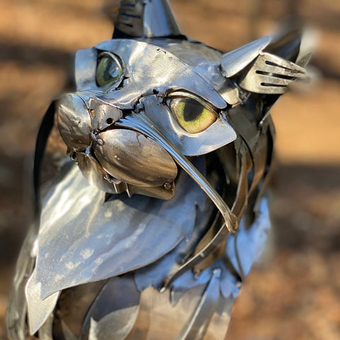 metal cat sculpture with realistic cat glass eyes