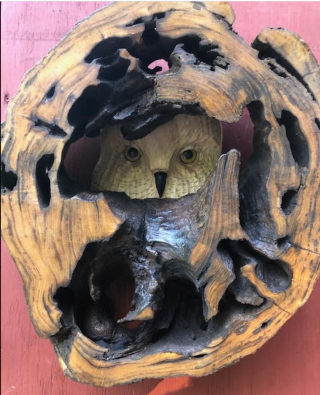 carved wood owl in hallowed out log