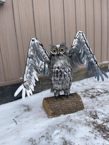 owl sculpture made out of forks and spoons