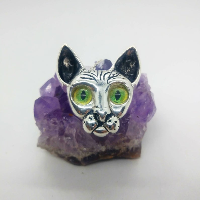 silver cat pendant with glass cat eyes